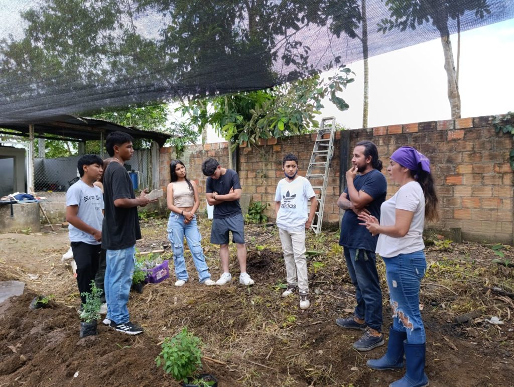 Estudiantes y funcionarios Batuta al aire libre en huerta medicinal de San Miguel